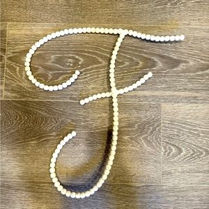RH Baby - Wood Beaded Letter F in Antiqued Grey, but is very light/whitish.